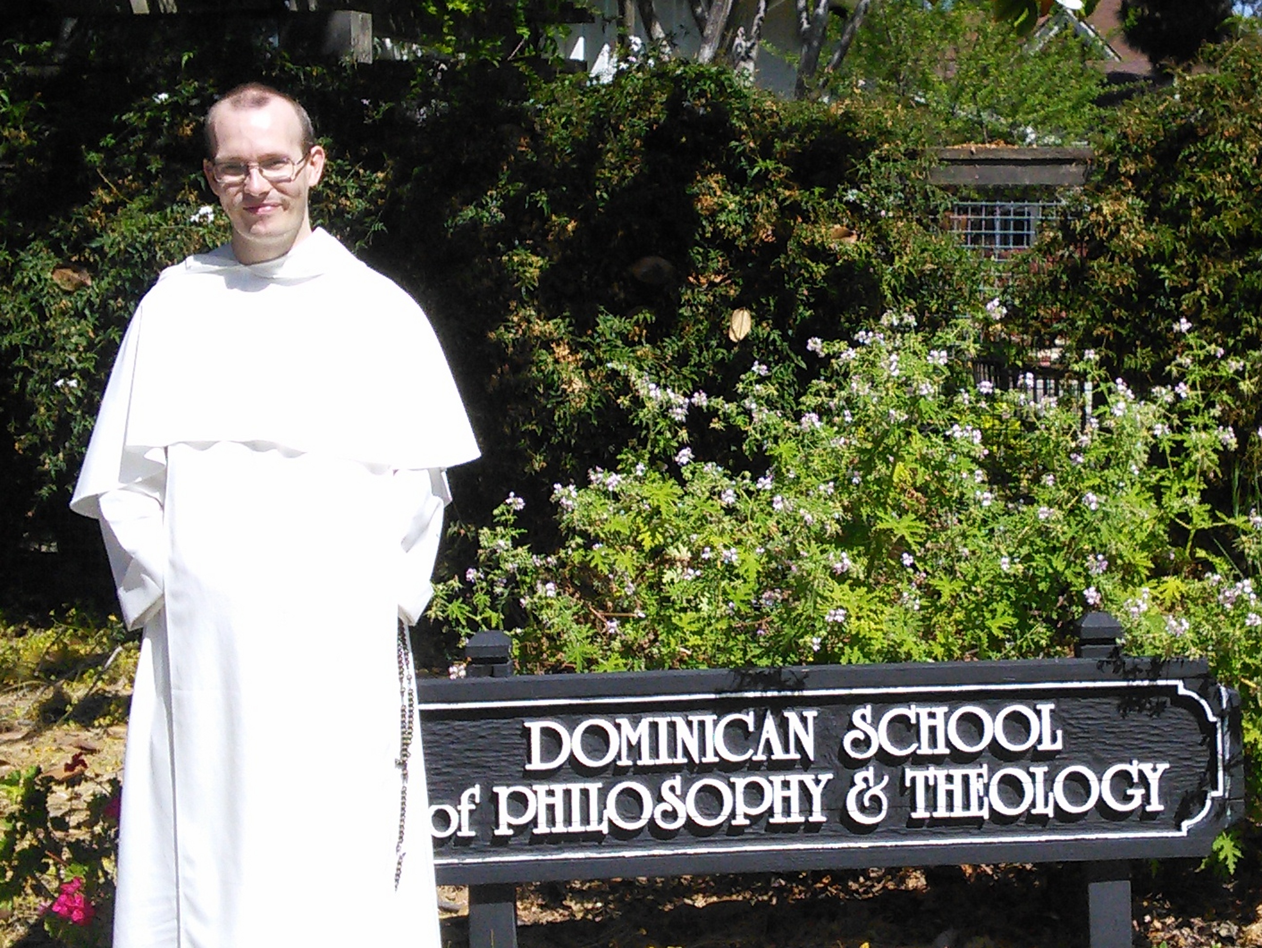Fr Robert Verill standing by the Dominican School of Philosophy and Theology